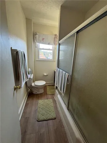a view of bathroom with a sink and mirror wooden floor