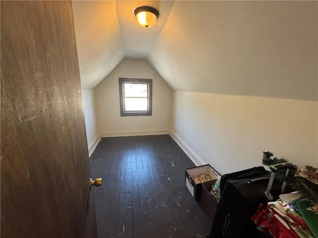 a view of a room with wooden floor and windows