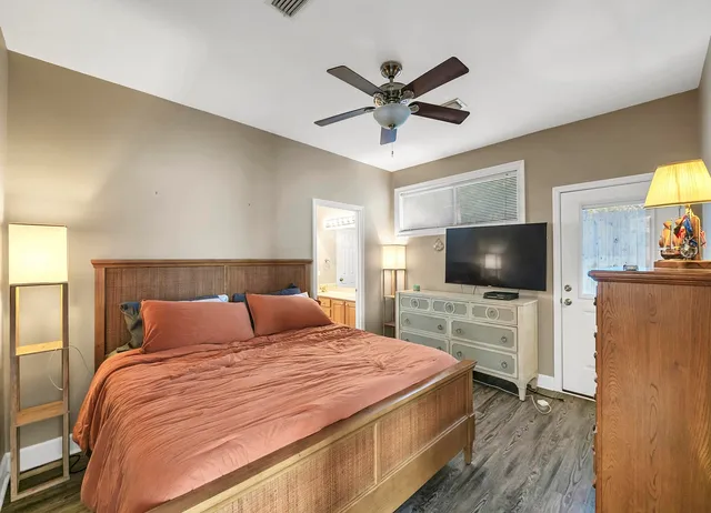 a bedroom with a bed and a flat screen tv