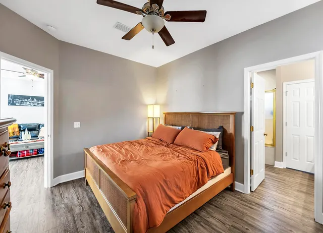 a bedroom with a bed and wooden floor
