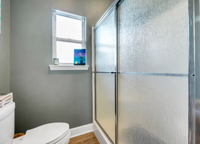 a bathroom with a toilet and a shower