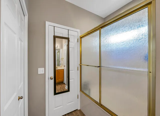 a bathroom with a glass shower door
