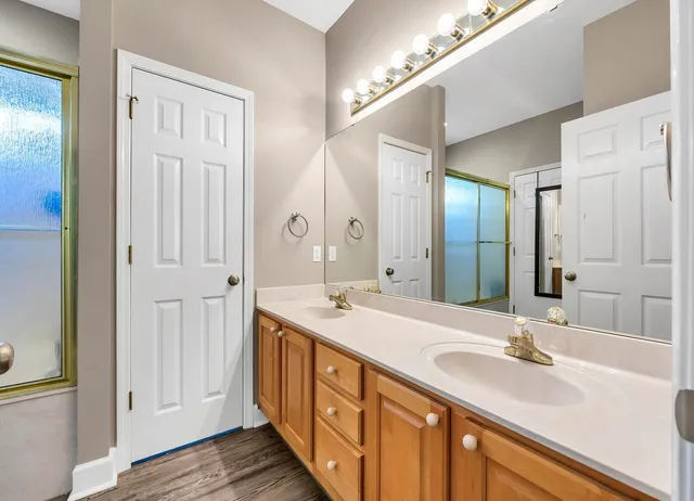a bathroom with a double vanity sink and a mirror
