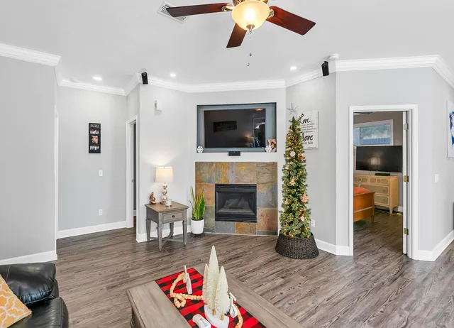a living room with furniture fireplace and flat screen tv