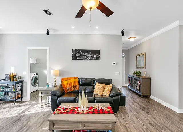 a living room with furniture and wooden floor