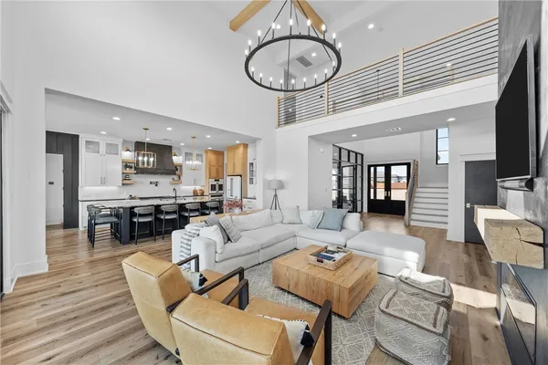 a kitchen with stainless steel appliances kitchen island granite countertop a table chairs and a refrigerator