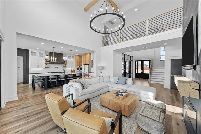 a kitchen with stainless steel appliances kitchen island granite countertop a table chairs and a refrigerator