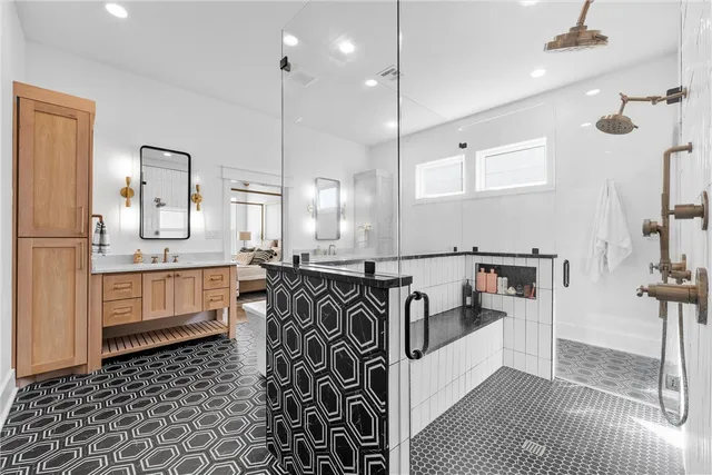 a bathroom with a granite countertop sink and a mirror