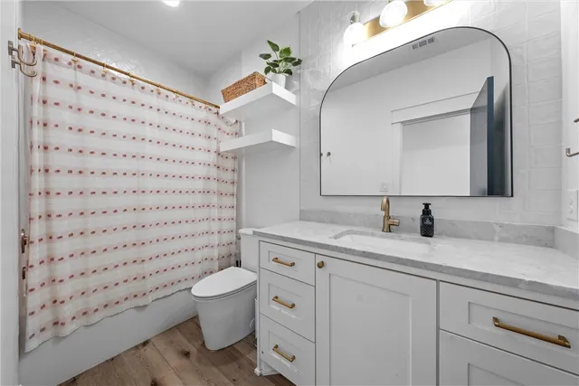 a living room with furniture a wooden floor and a large window