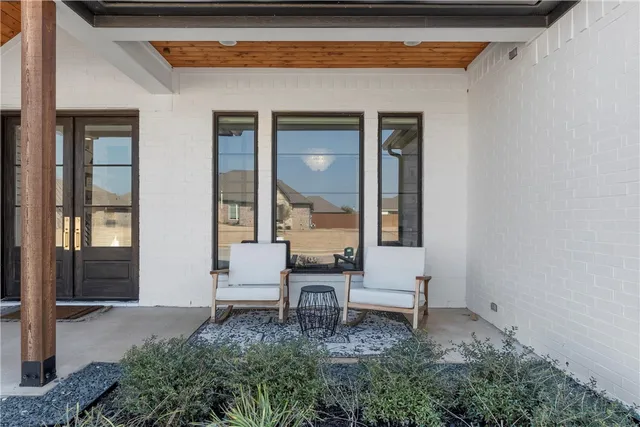 a backyard of a house with table and chairs