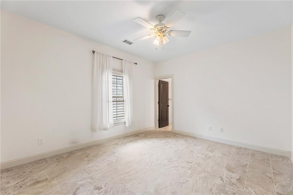6645 Will Allen Road Cumming, GA 30040 - Photo 35 of 62 an empty room with chandelier fan and windows