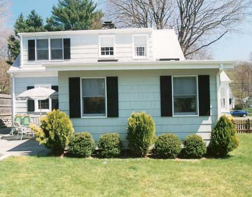 Undisclosed Address Darien, CT 06820 - Photo 2 of 8 a front view of a house with garden