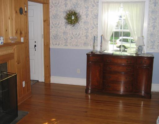 Undisclosed Address Darien, CT 06820 - Photo 4 of 8 an empty room with wooden floor and windows