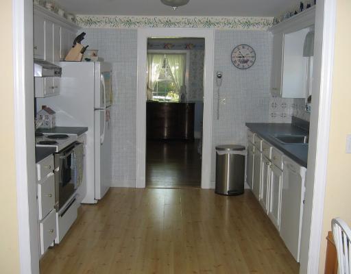 Undisclosed Address Darien, CT 06820 - Photo 6 of 8 a kitchen with a refrigerator and a stove top oven