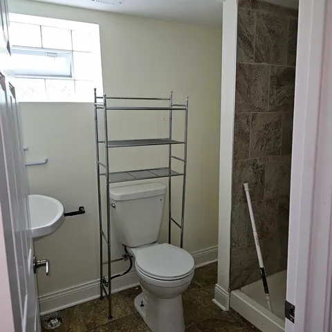 a bathroom with a toilet and a shower