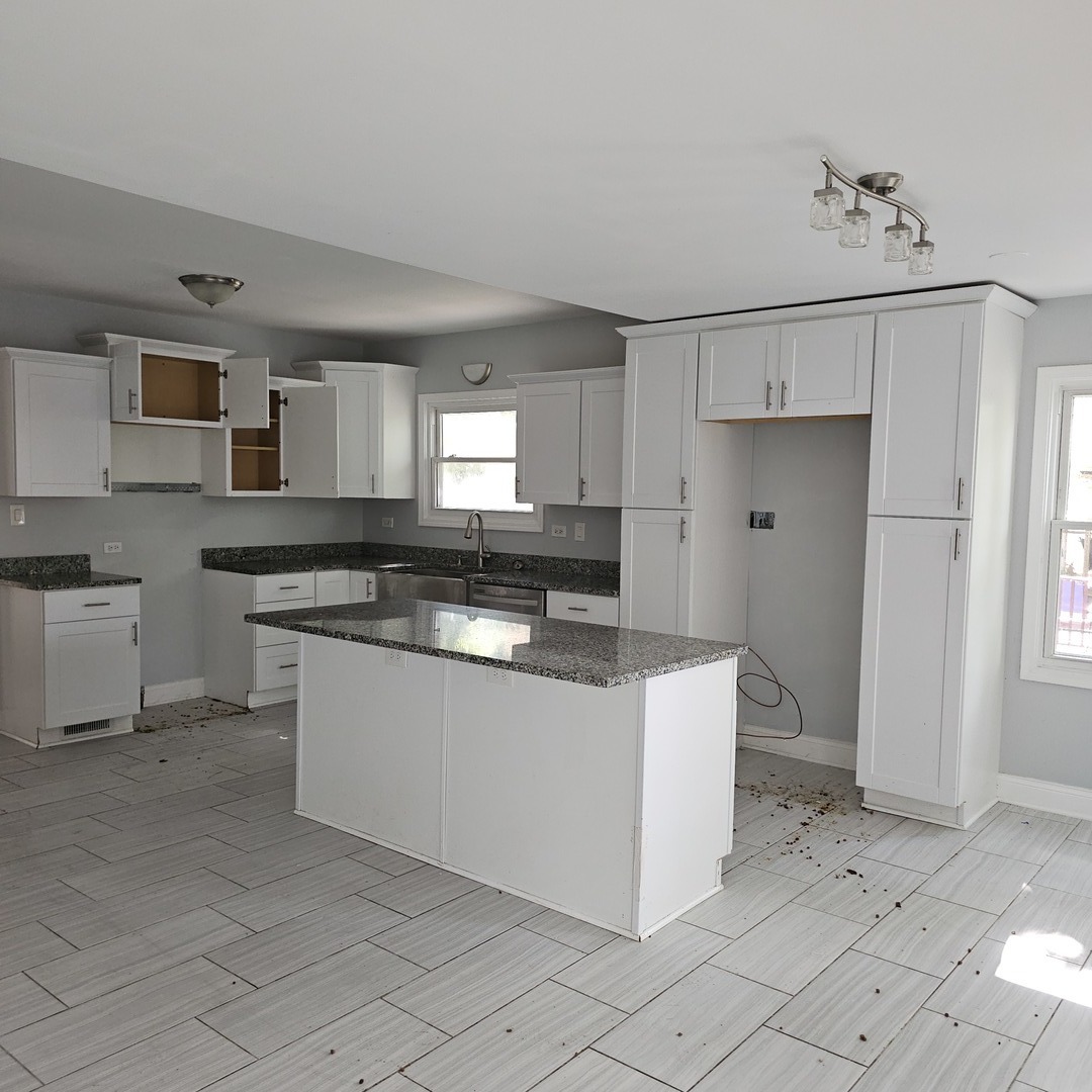 1750 183rd Street Homewood, IL 60430 - Photo 2 of 14 a kitchen with granite countertop white cabinets and white appliances