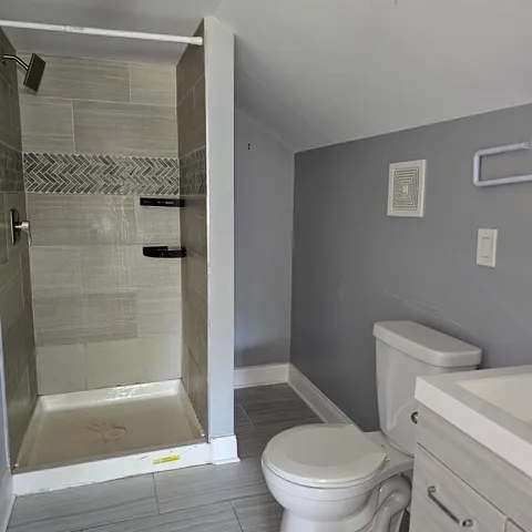 a bathroom with a toilet and a shower