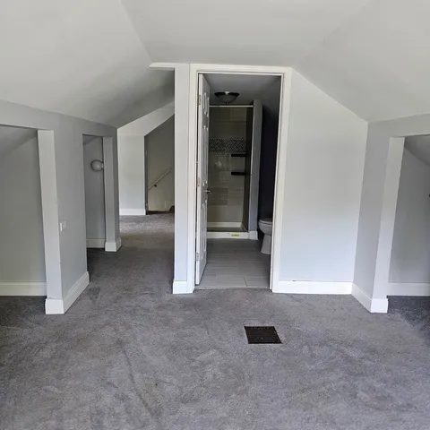 an empty room with closet and a bathroom