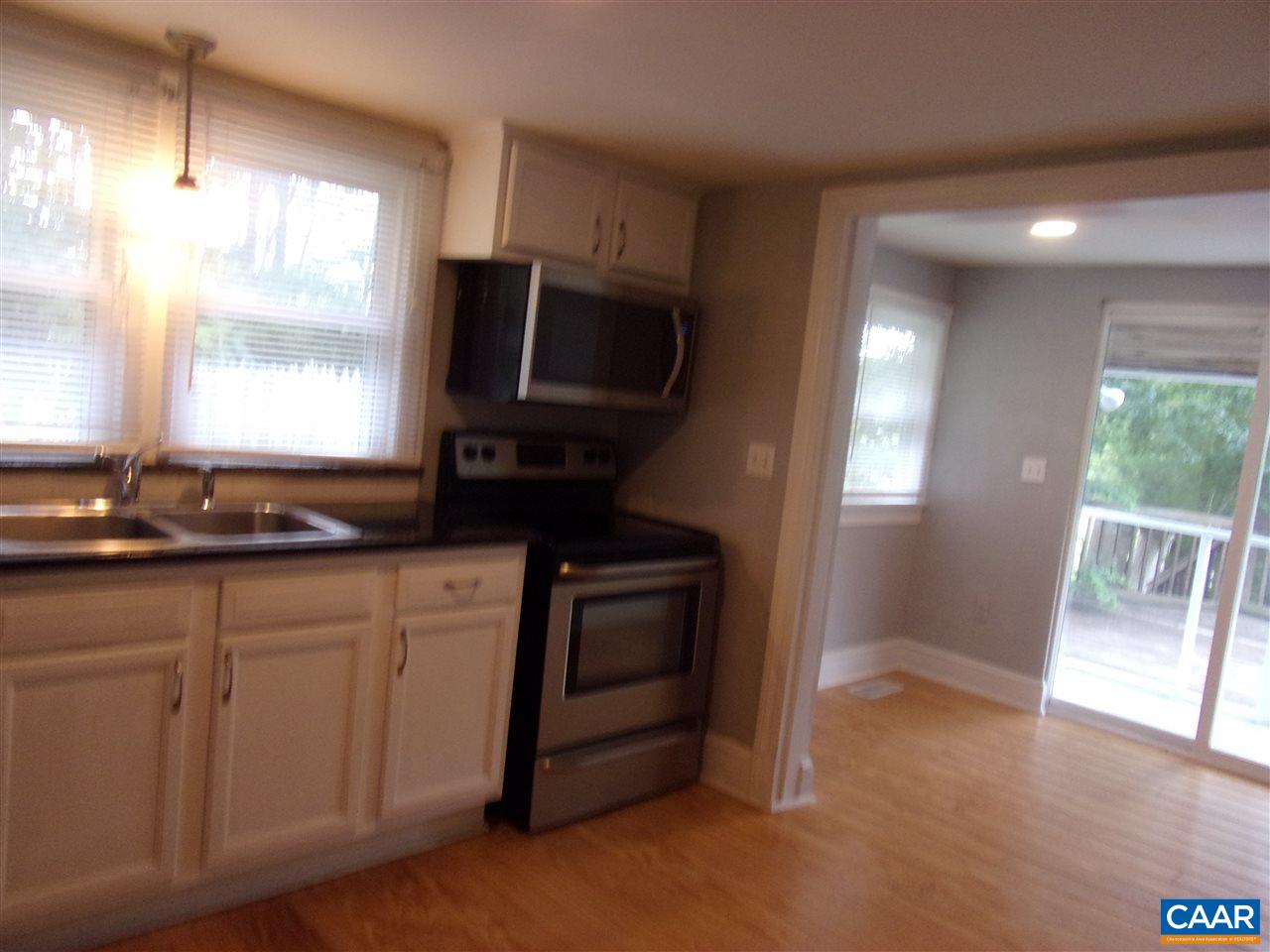 765 Three Chopt Road Kents Store, VA 23084 - Photo 8 of 31 a kitchen with granite countertop a stove a sink and a microwave