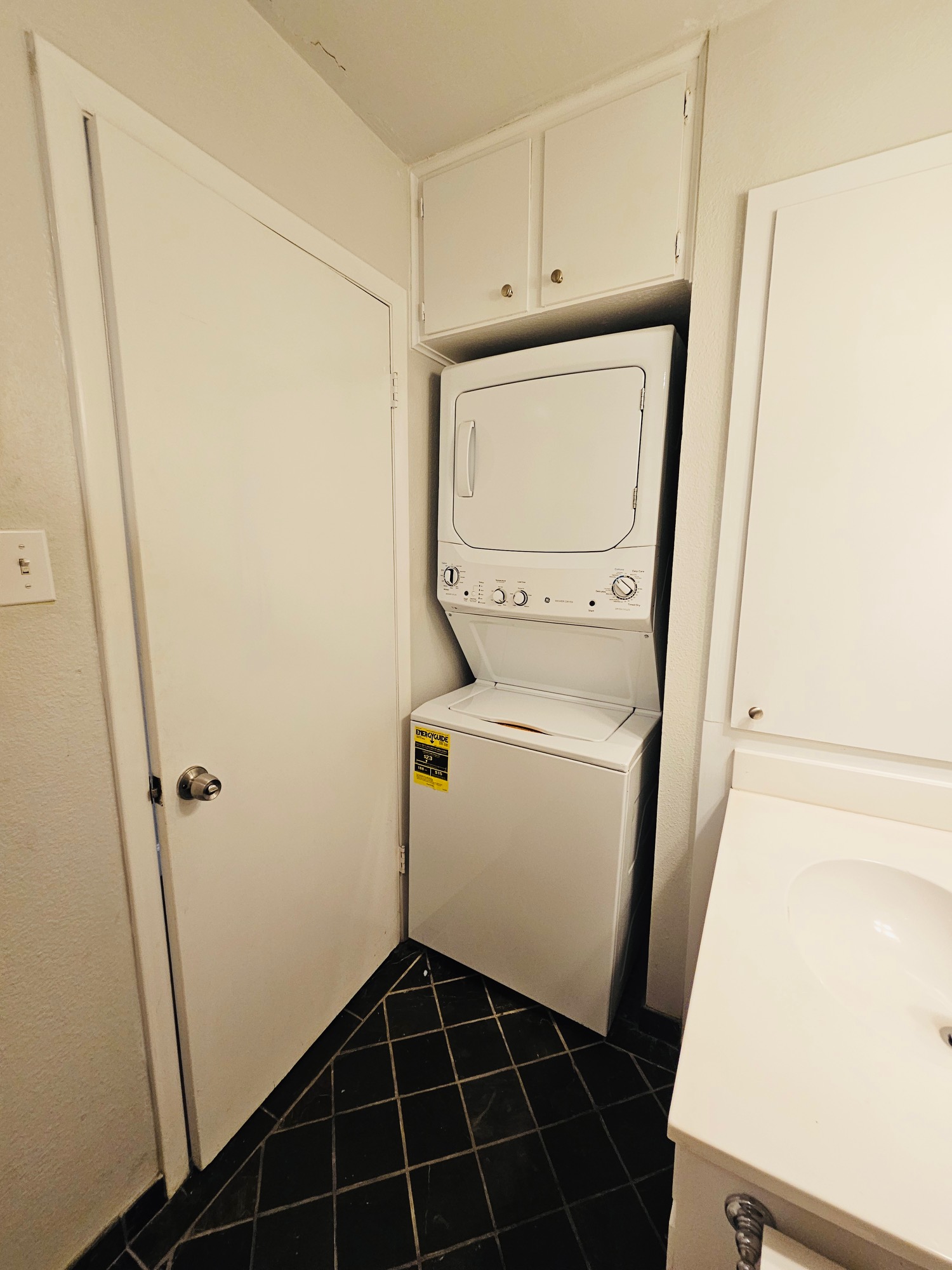 5107 Leralynn Street, Unit 304 Austin, TX 78751 - Photo 19 of 28 Washroom with stacked washer / dryer, dark tile patterned floors, and laundry area