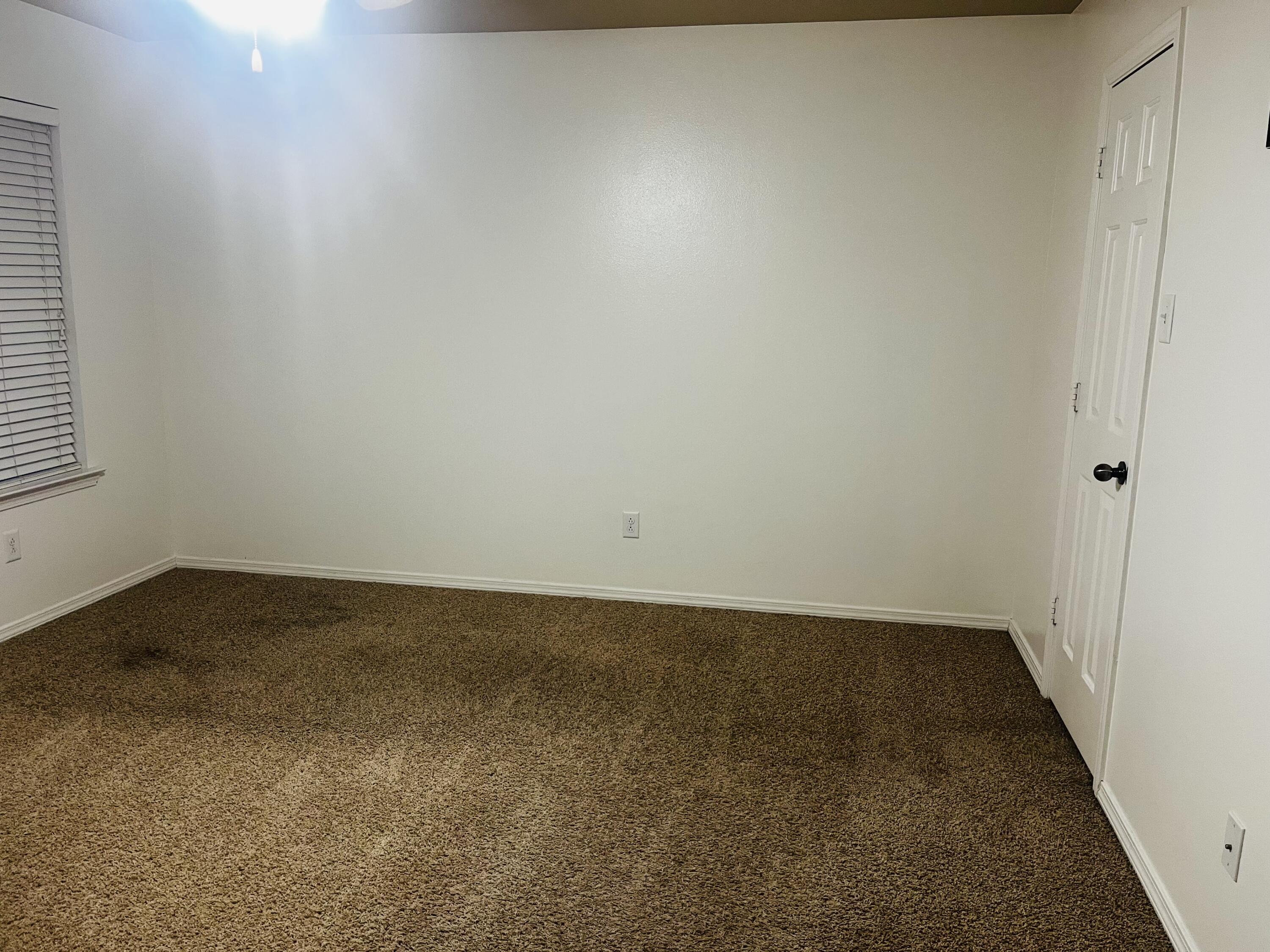 10016 Weatherford Avenue Lubbock, TX 79423 - Photo 12 of 29 an empty room with a bench