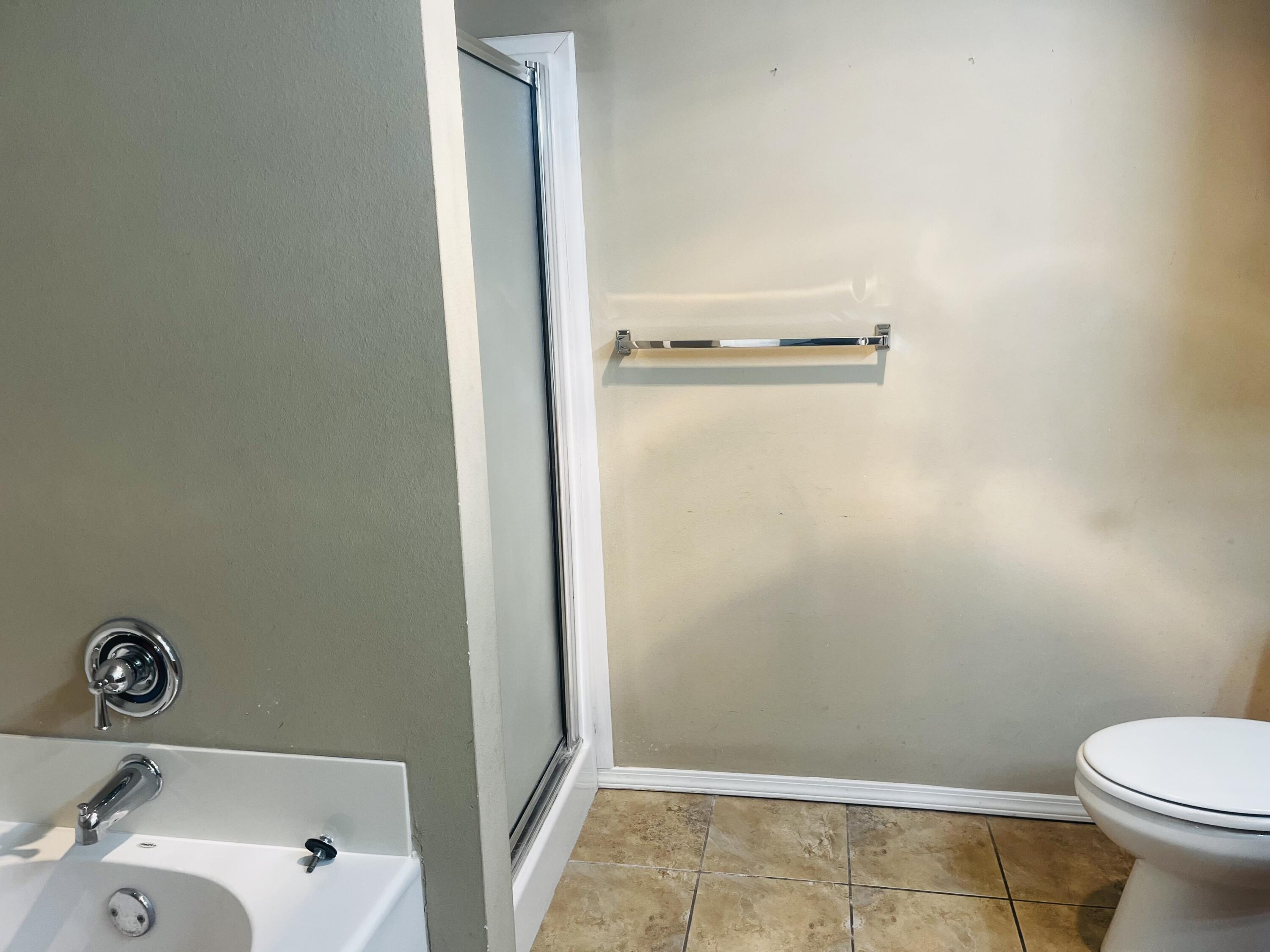 10016 Weatherford Avenue Lubbock, TX 79423 - Photo 16 of 29 a bathroom with a granite countertop toilet and a sink