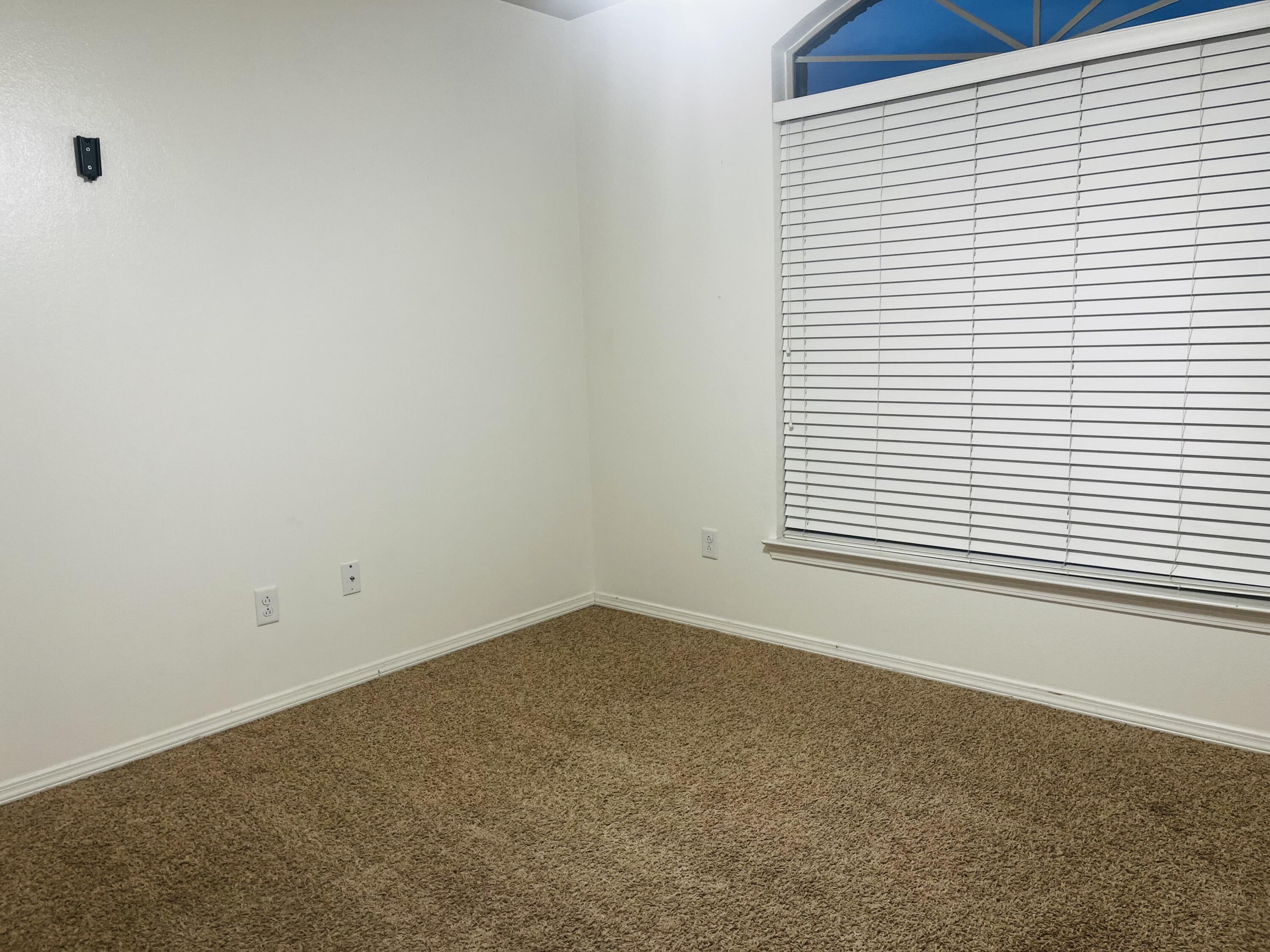 10016 Weatherford Avenue Lubbock, TX 79423 - Photo 22 of 29 an empty room with a window