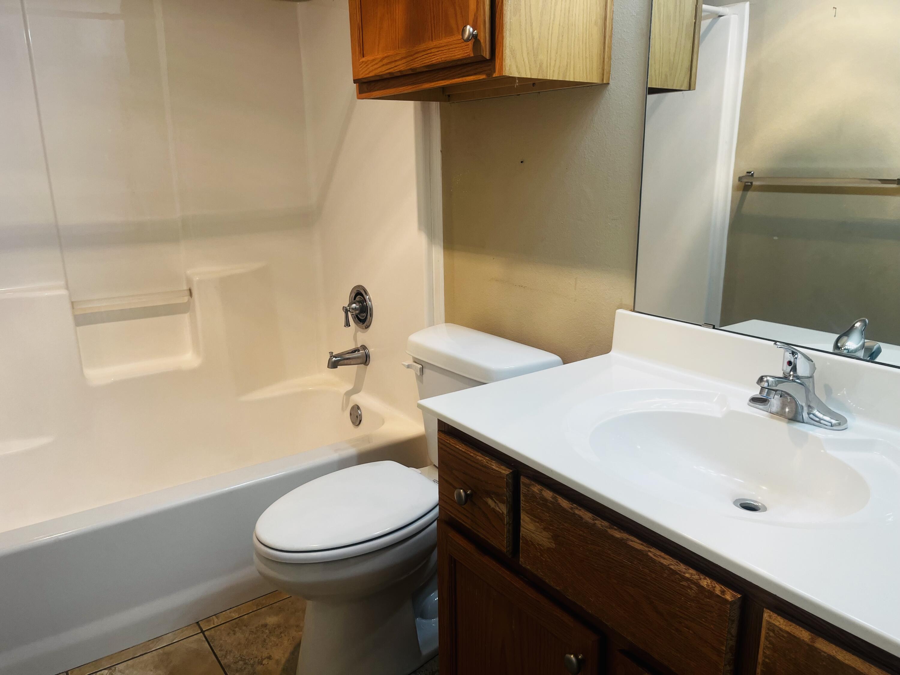 10016 Weatherford Avenue Lubbock, TX 79423 - Photo 23 of 29 a bathroom with a sink a toilet and shower