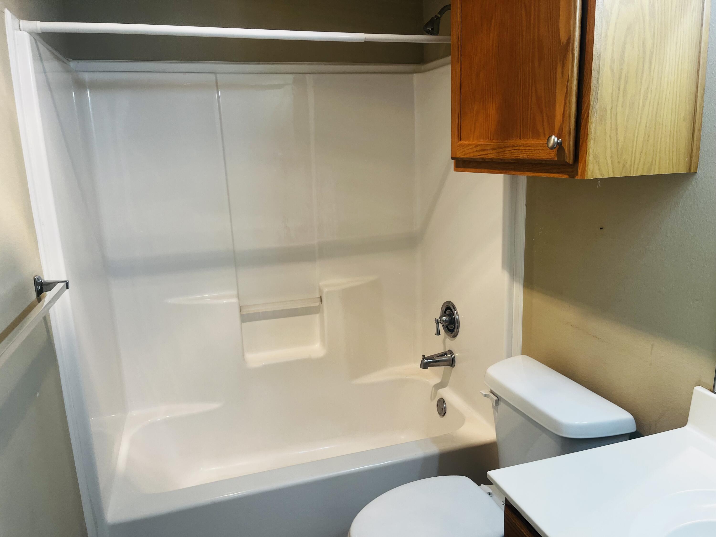 10016 Weatherford Avenue Lubbock, TX 79423 - Photo 24 of 29 a bathroom with a toilet and a bathtub