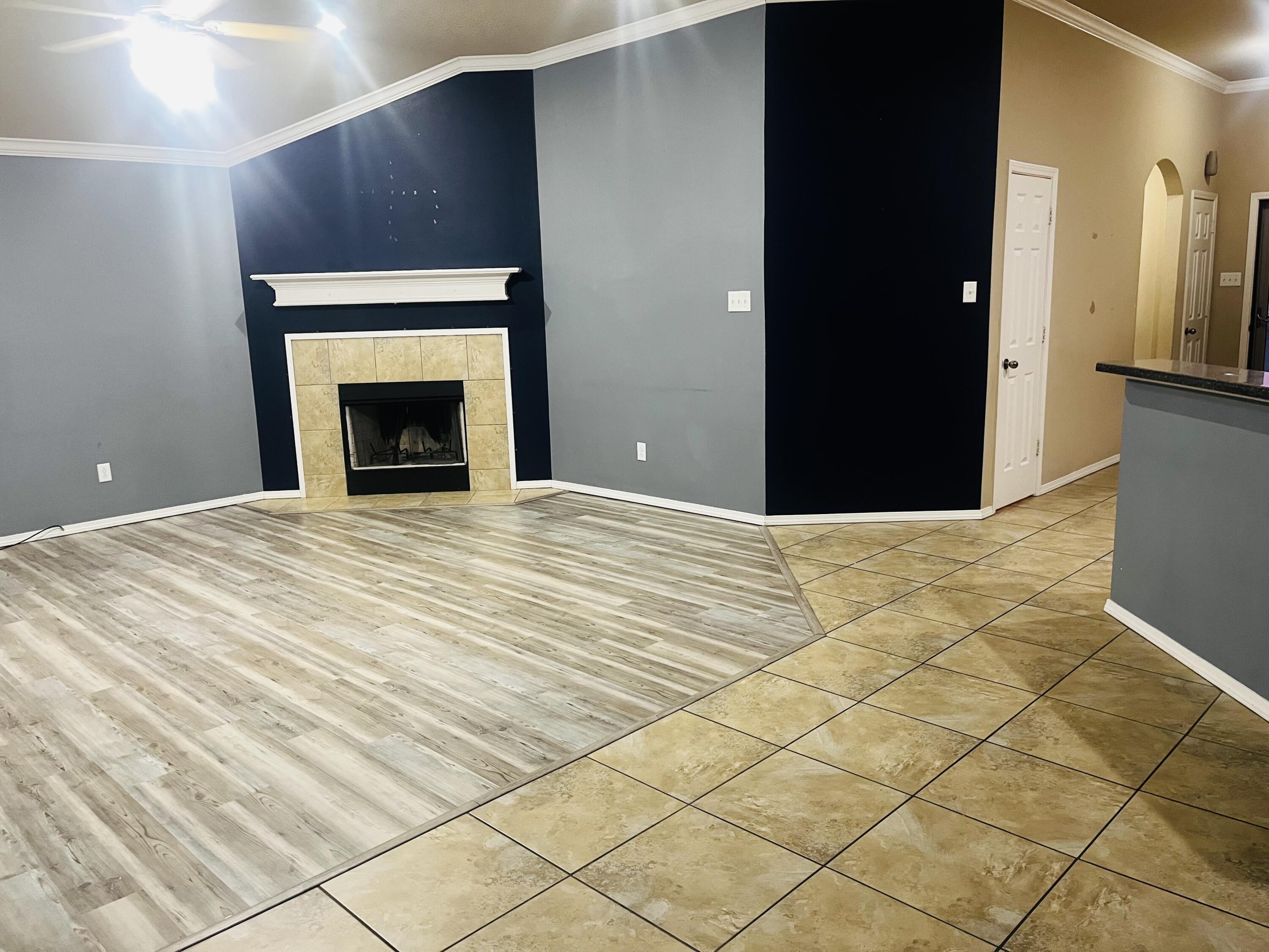 10016 Weatherford Avenue Lubbock, TX 79423 - Photo 6 of 29 a view of an empty room with wooden floor
