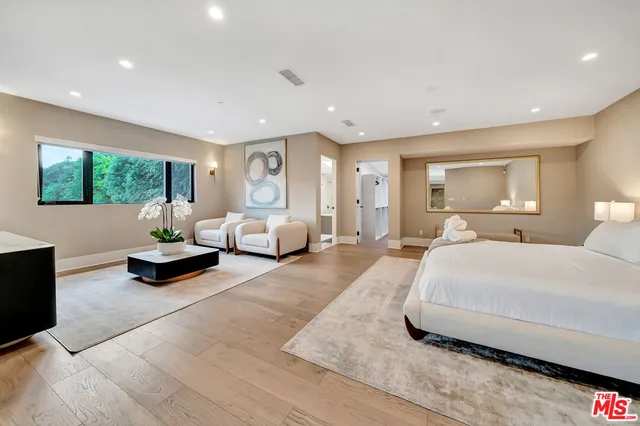 a spacious bedroom with a large bed and a couch