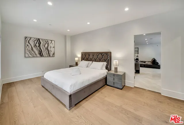 a spacious bedroom with a bed and a view of bathroom