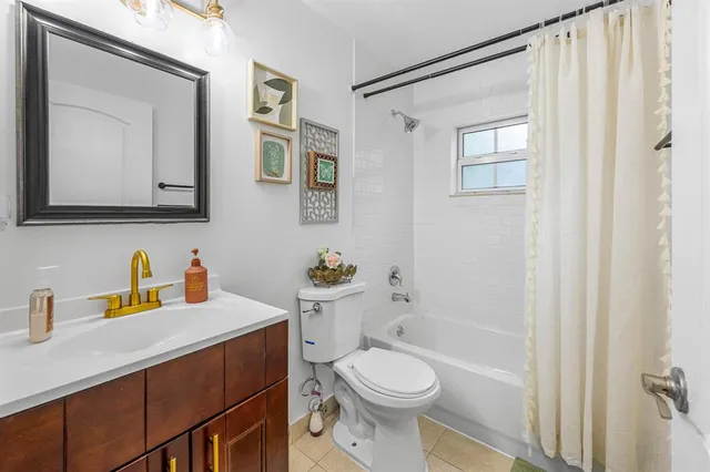 a bathroom with a sink a toilet and shower curtain