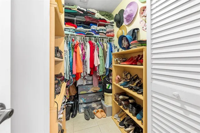 a view of walk in closet with clothes