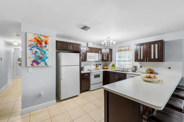 a kitchen with a refrigerator and a sink