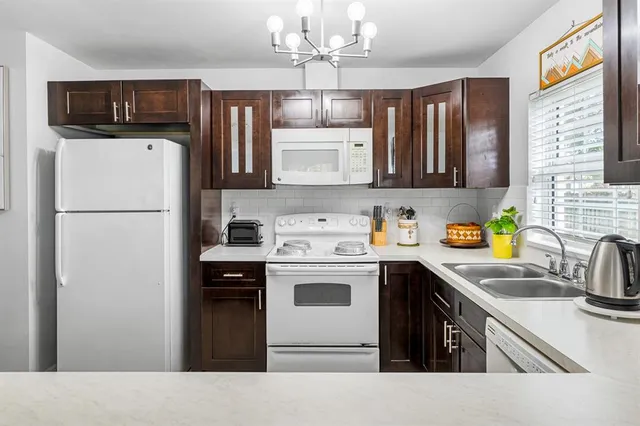 a kitchen with a sink a stove and refrigerator