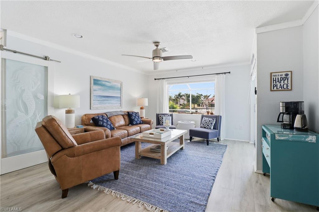 2211 Bayview Road Punta Gorda, FL 33950 - Photo 16 of 37 a living room with furniture and a wooden floor