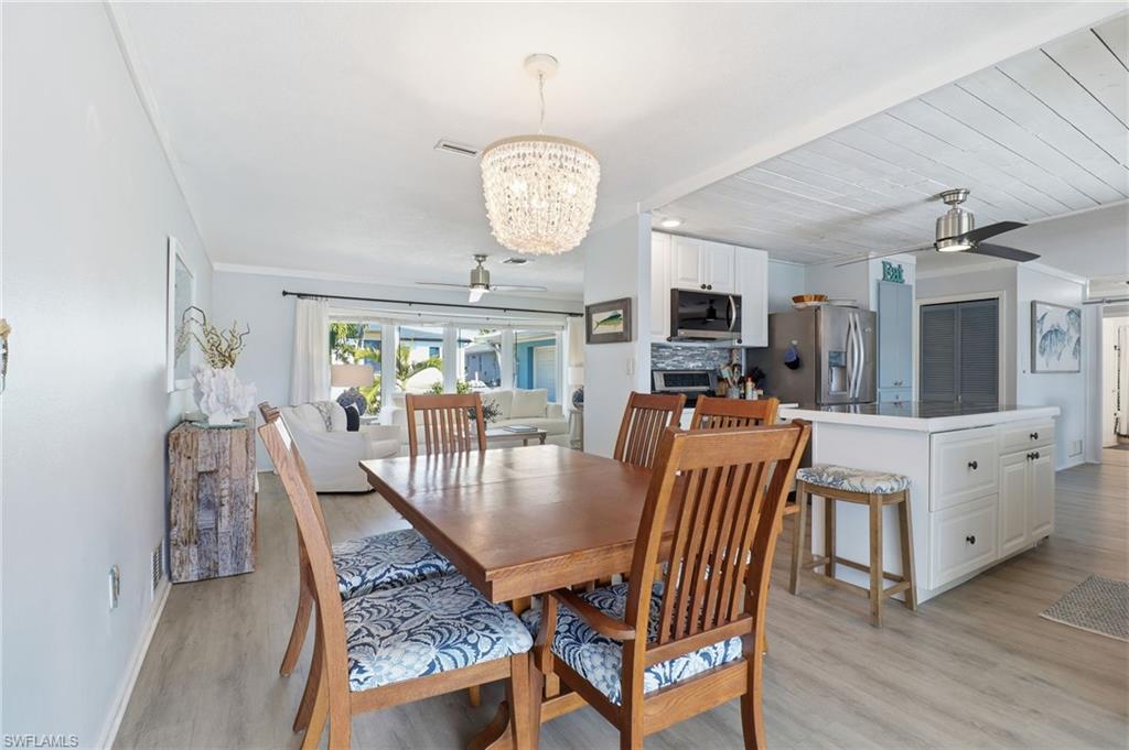 2211 Bayview Road Punta Gorda, FL 33950 - Photo 18 of 37 a view of a dining room with furniture window and wooden floor