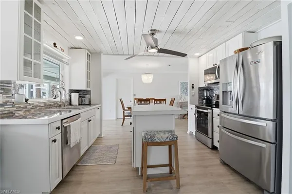 a kitchen with a sink stainless steel appliances and cabinets