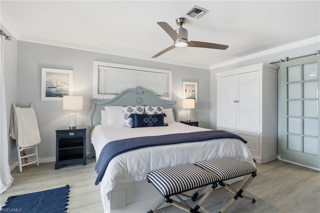 2211 Bayview Road Punta Gorda, FL 33950 - Photo 25 of 37 a bedroom with a bed and wooden floor