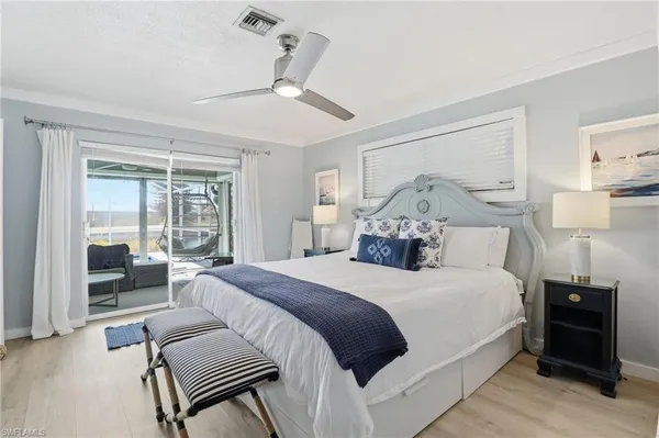 a bedroom with a large bed couch and a window