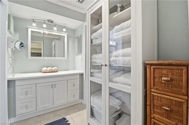 a bathroom with a shower a sink and a mirror