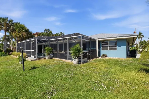 a view of a house with backyard porch and sitting area