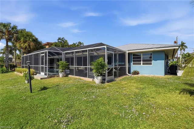 a view of a house with backyard porch and sitting area