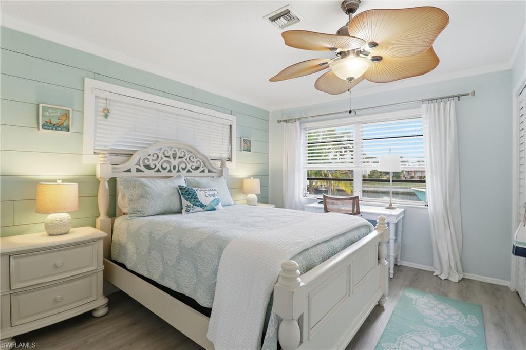 2211 Bayview Road Punta Gorda, FL 33950 - Photo 31 of 37 a bedroom with a bed and a chandelier