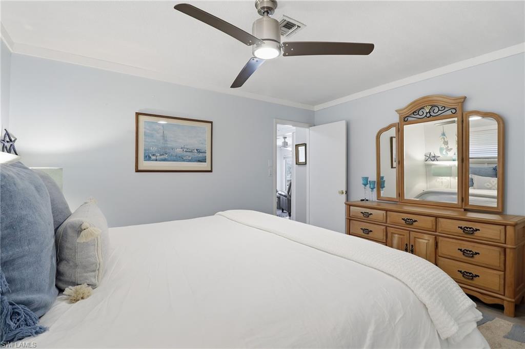2211 Bayview Road Punta Gorda, FL 33950 - Photo 35 of 37 a bedroom with a bed a mirror and a window