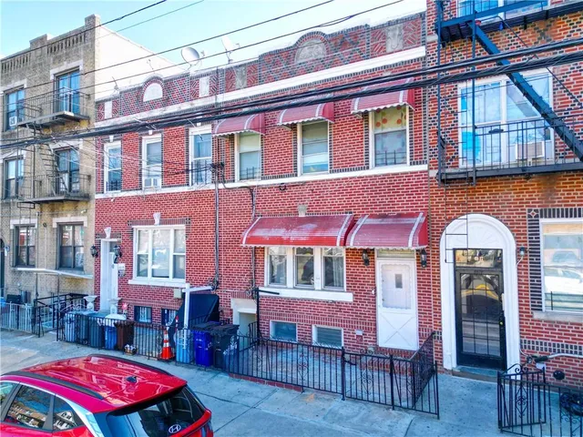 a front view of a building with outdoor seating