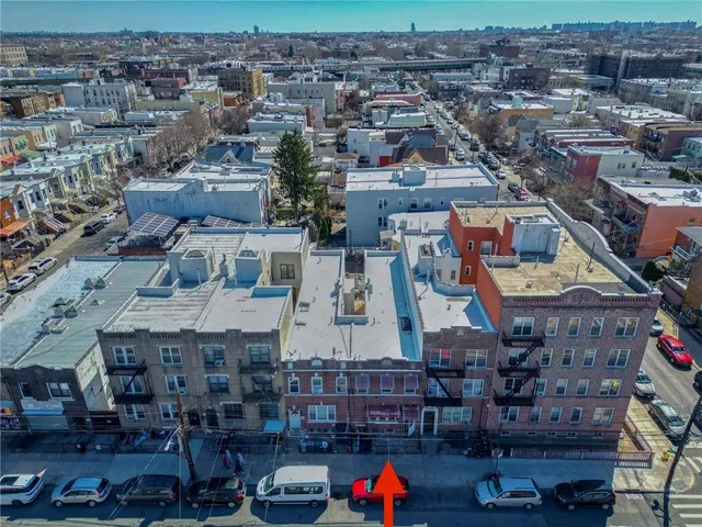 an aerial view of a building with parked cars