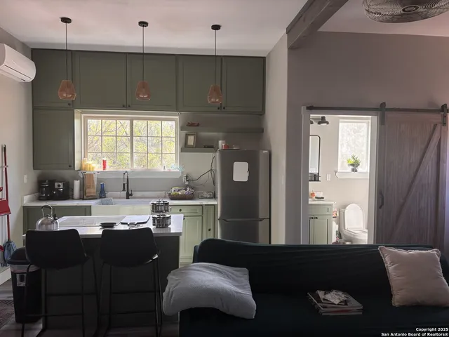 a kitchen with a table chairs sink and cabinets