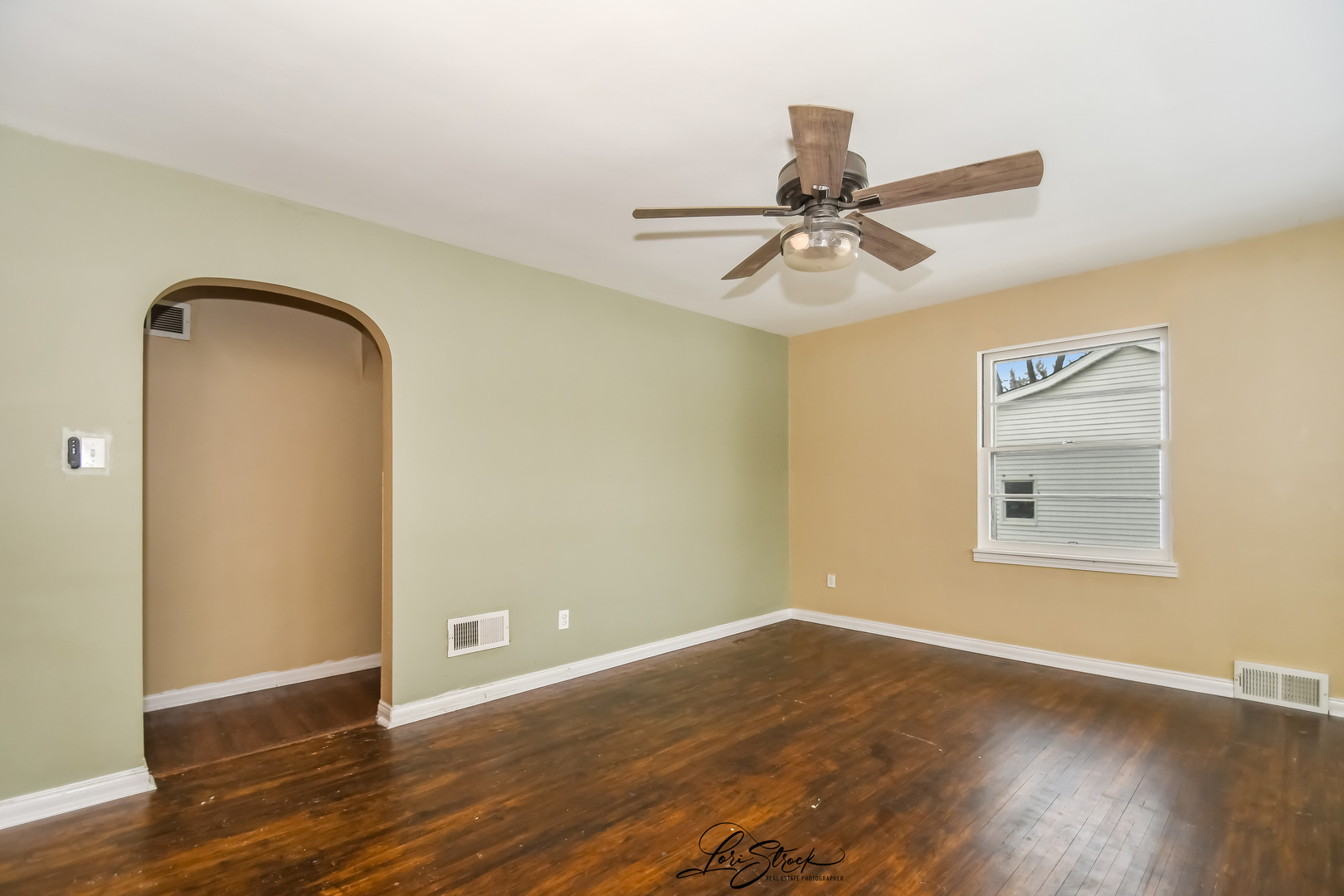 1009 Helen Avenue Joliet, IL 60433 - Photo 6 of 23 a view of a room with wooden floor and a ceiling fan